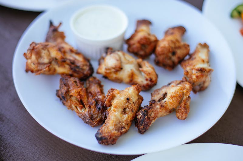 Buffalo wings tossed in spicy sauce with blue cheese dip