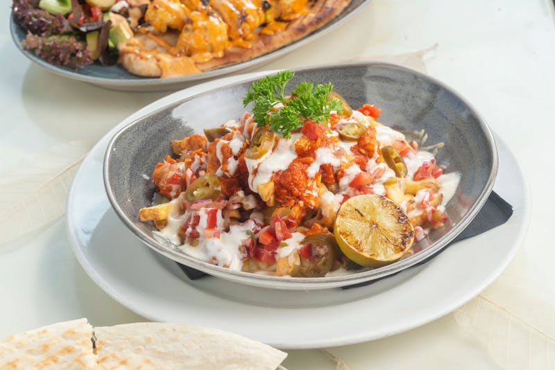 Loaded nachos with cheese, jalapenos and sour cream